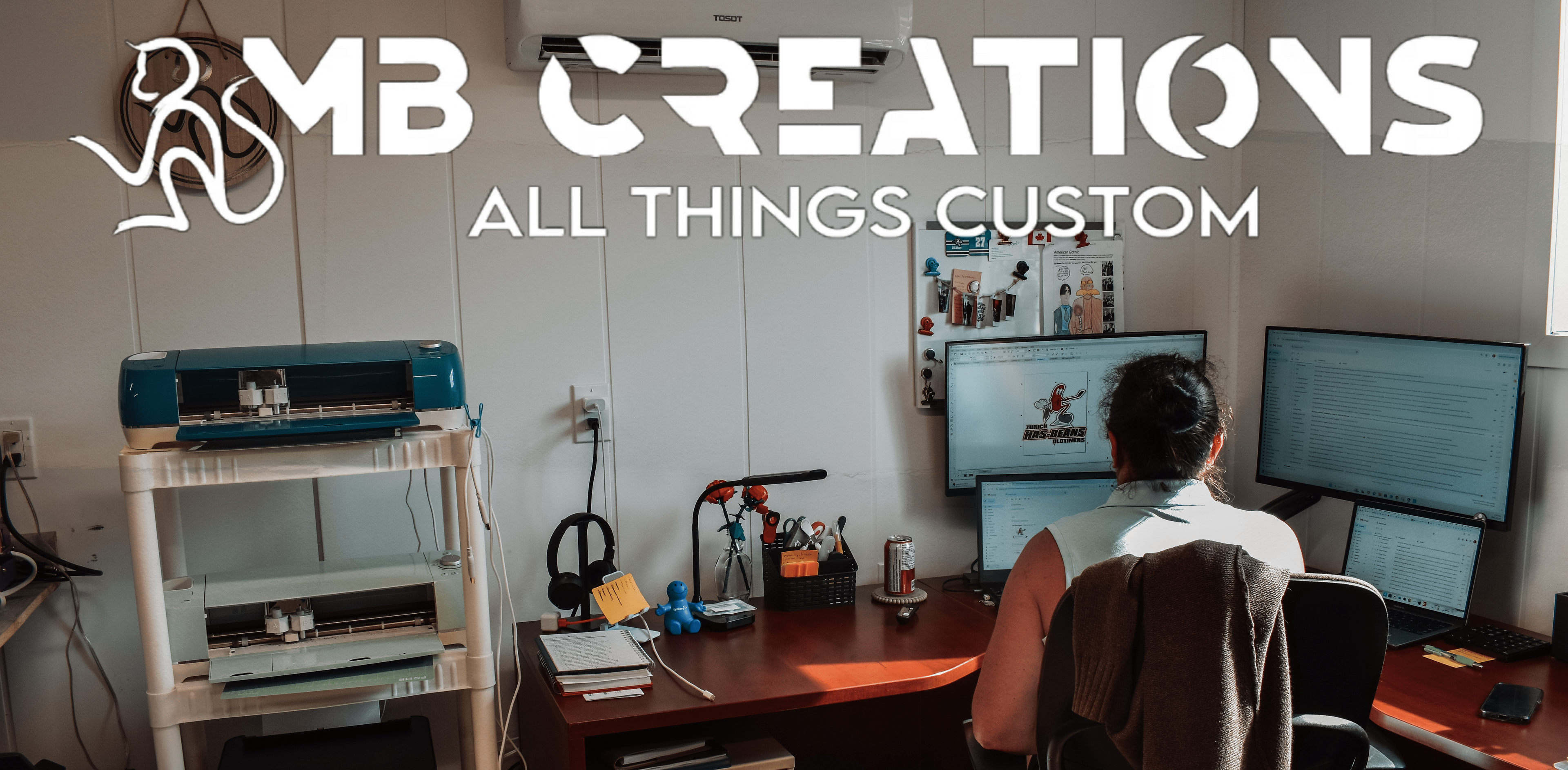 Person working at a desk with computer monitors, surrounded by office equipment, with 'MB Creations' branding.